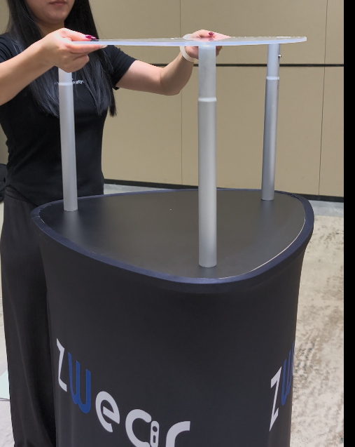 One person installing an acrylic shelf on a portable display tower