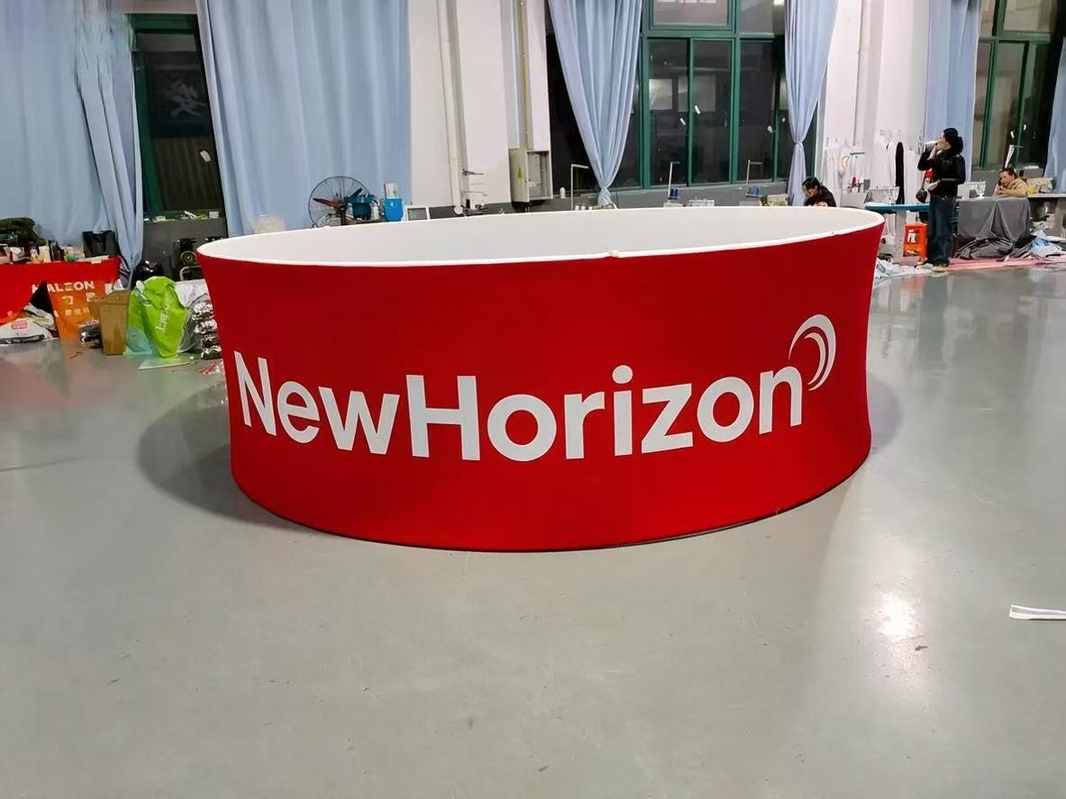 Completed 4 metre circular trade show hanging banner with red stretch fabric graphic