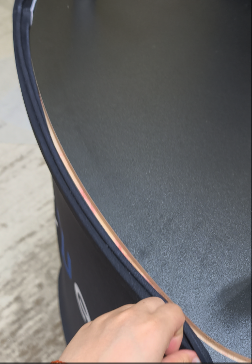 Close-up of printed stretch fabric being secured around the counter edge