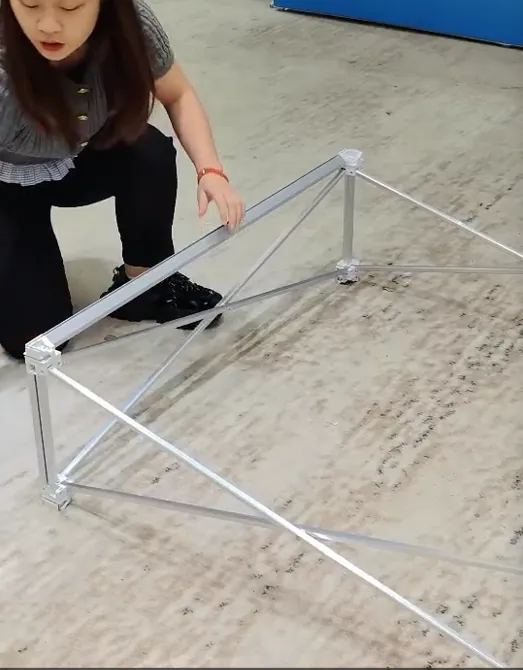 One person opening the first section of a collapsible pop-up display counter frame