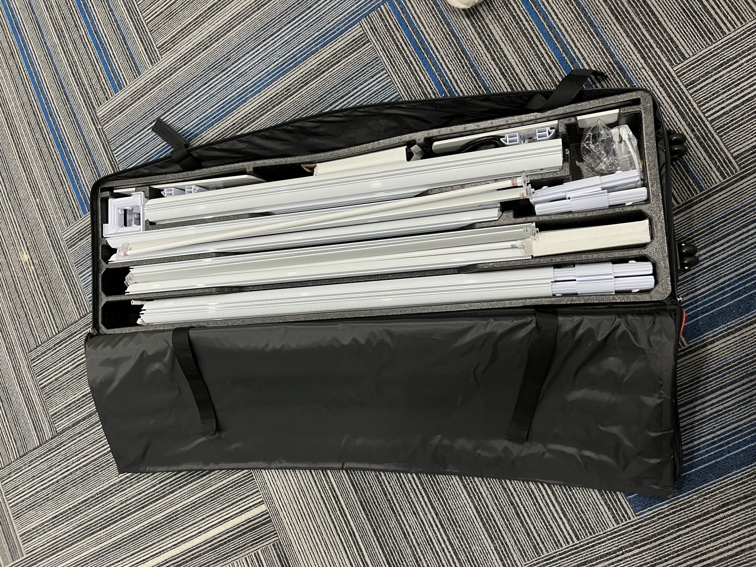 Portable aluminum lightbox components packed in a carry case