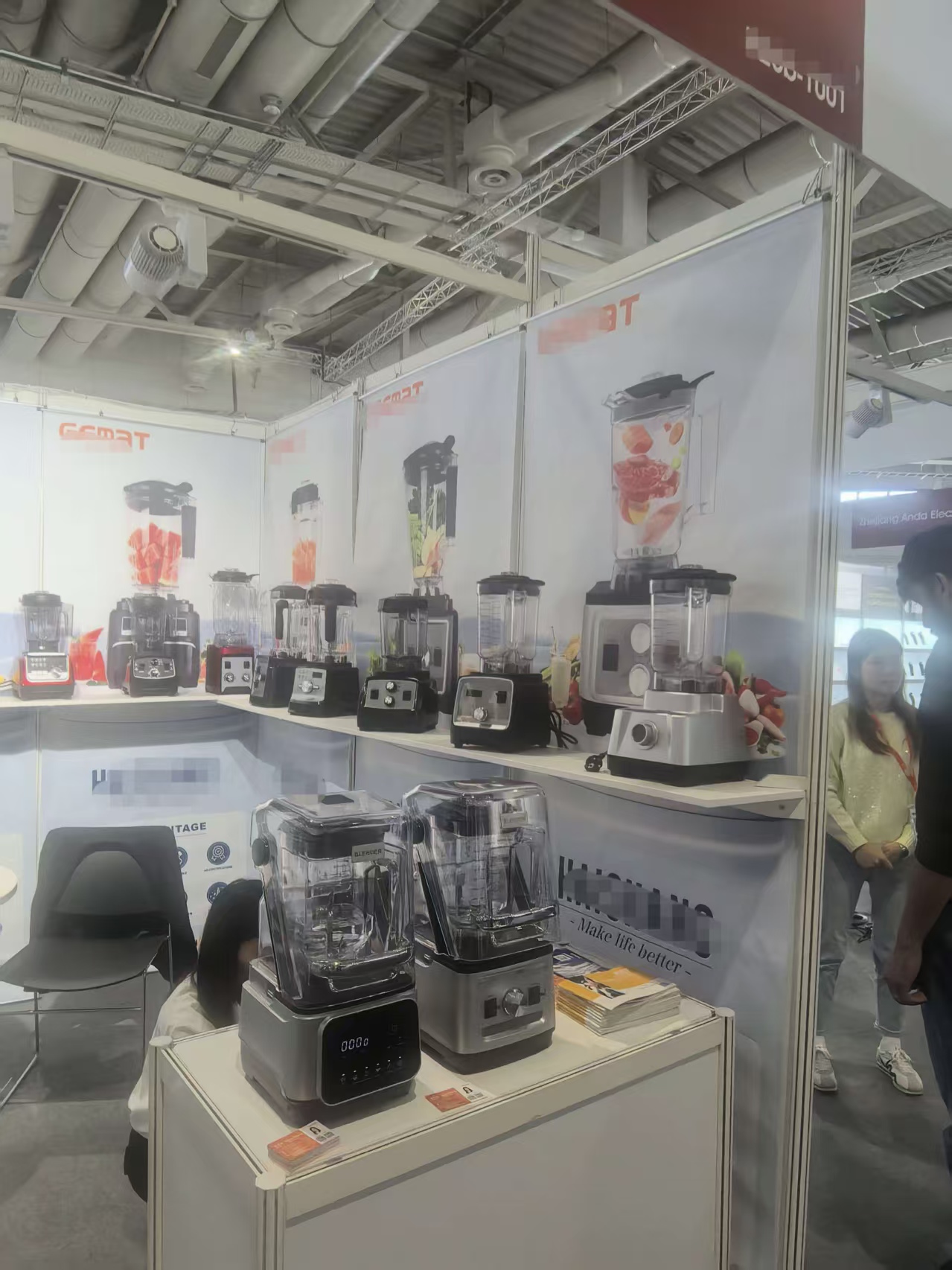 Hanging scroll banner panels displaying blender products in a Berlin standard booth