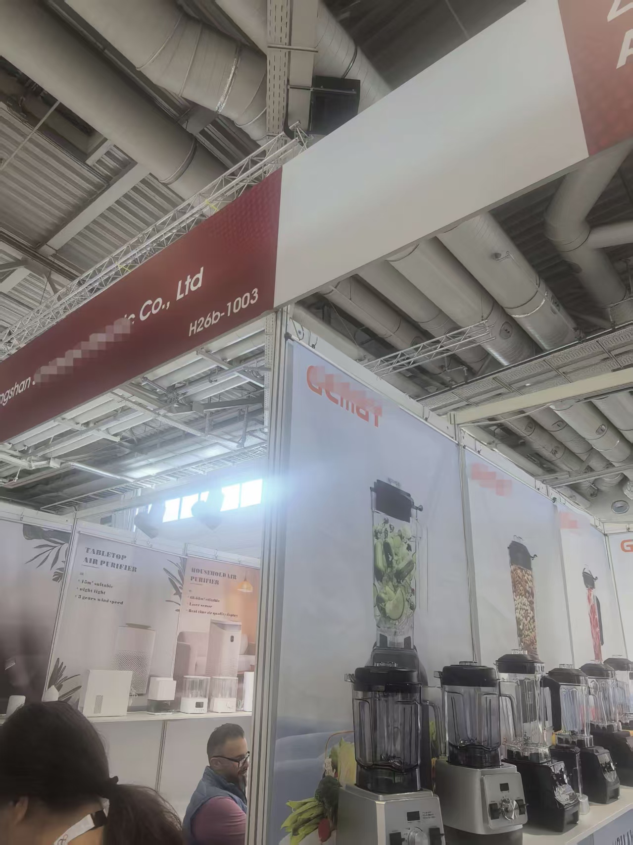 Portable hanging scroll graphics installed on the walls of a shell-scheme booth in Berlin