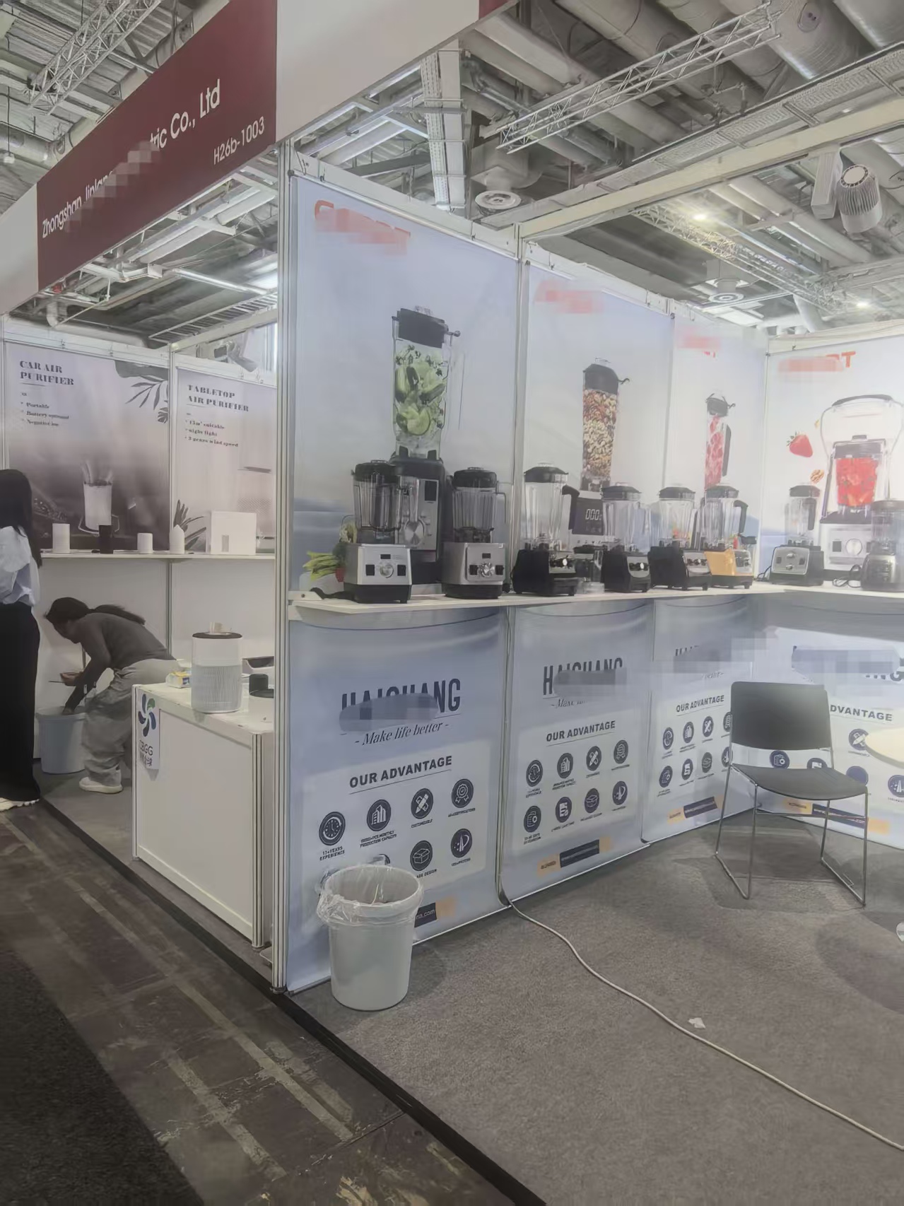 Completed Berlin exhibition booth with coordinated hanging banner and counter graphics