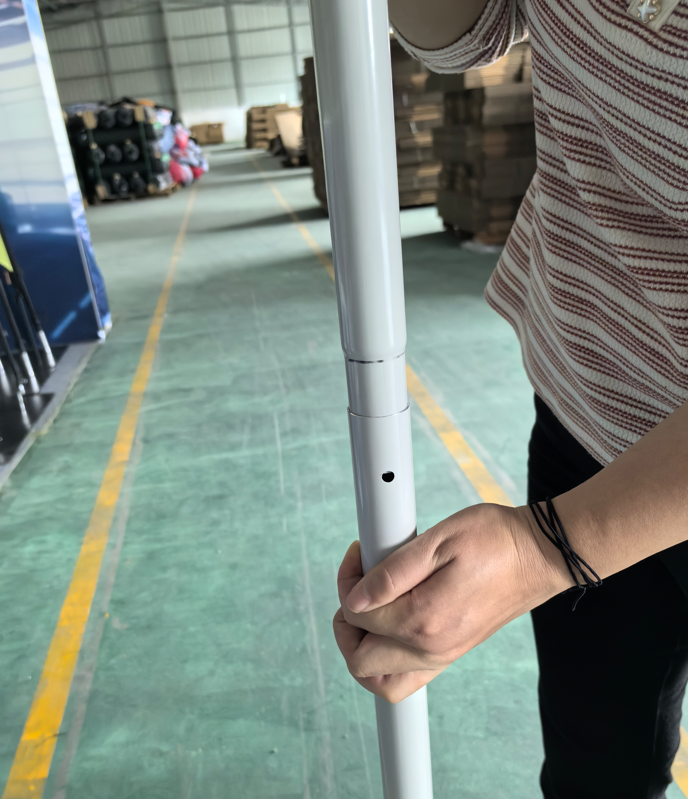 Installer holding aligned aluminum tube sections before completing the push-button joint.