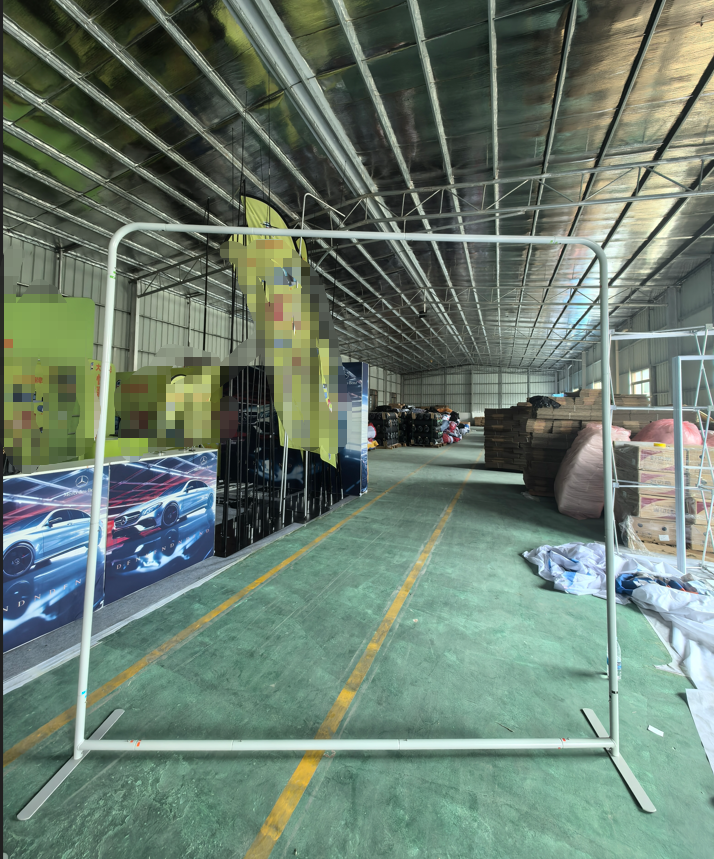 Assembled rectangular aluminum tube display frame with rounded upper corners, a lower rail and two support feet.