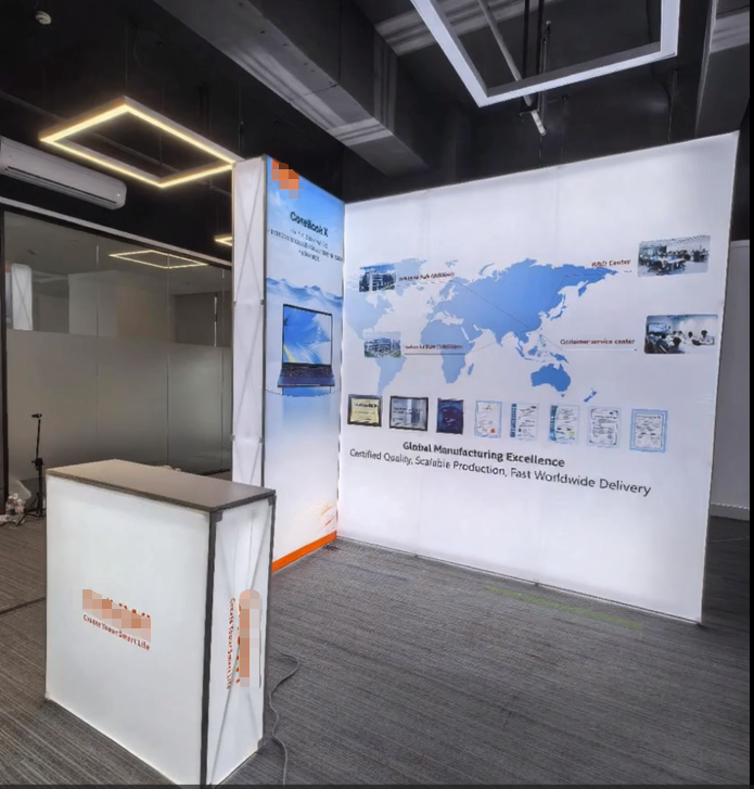 Illuminated corner display with a world-map graphic, a narrow side panel, and a separate reception counter.